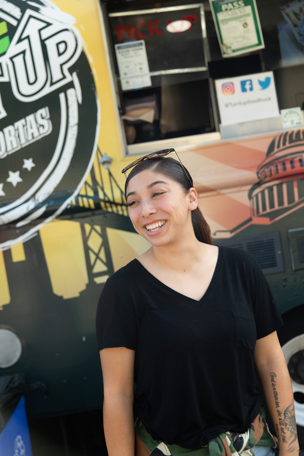 Holy Names University student smiling in front of food truck in Oakland, California