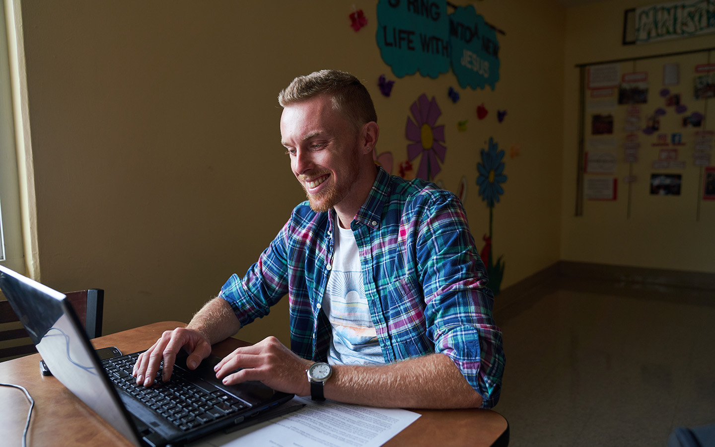 Holy Names University student working on their laptop