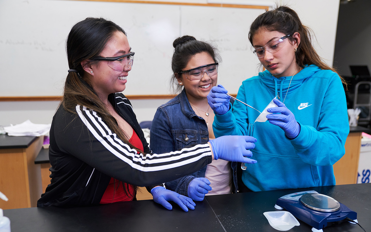 Three HNU students working on a lab together